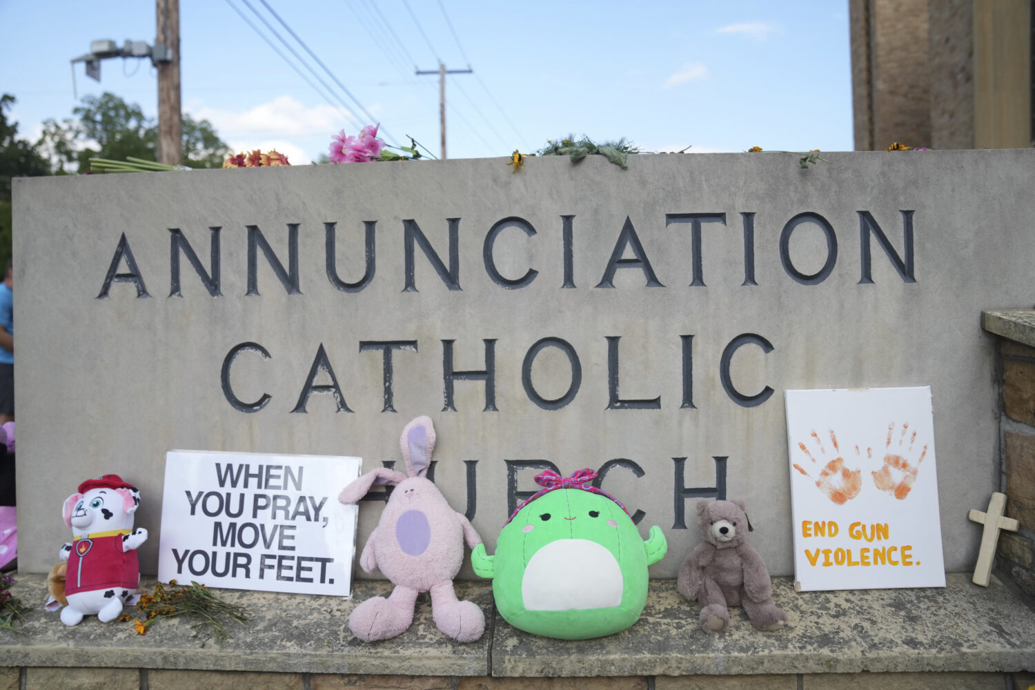 Items are left at a memorial at Annunciation Catholic Church after Wednesday's school shooting, Thu...