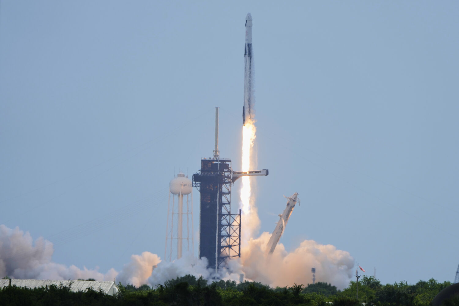A SpaceX Falcon 9 rocket, carrying a Dragon capsule with a U.S.-Japanese-Russian crew of four, lift...