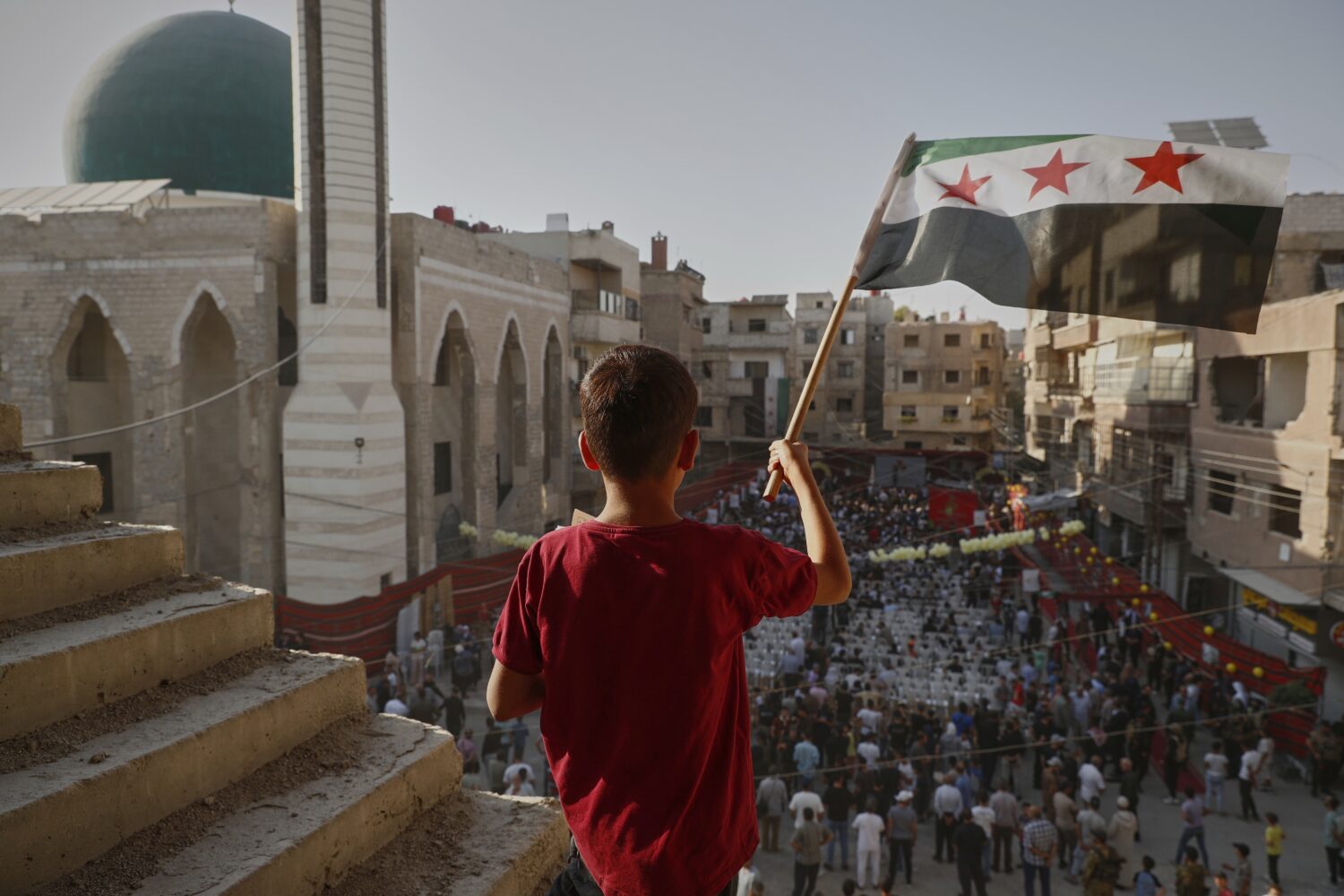 Syrians gather to mark the anniversary of a chemical weapons attack carried out by Bashar Assad's f...