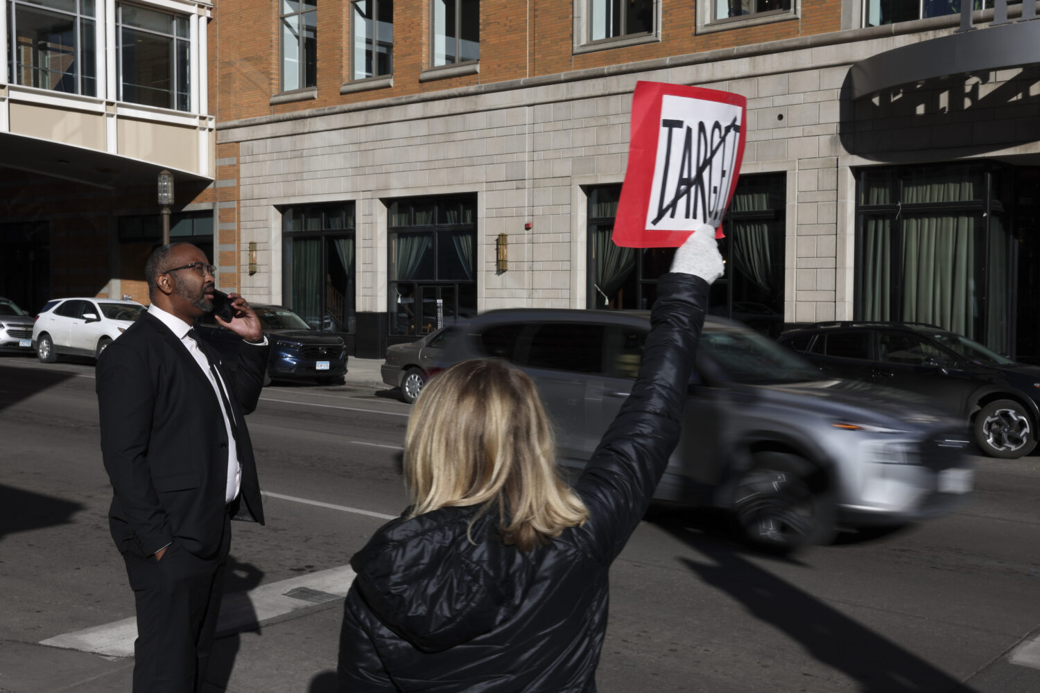FILE - Becky Dankowski, center, of Minneapolis, holds an anti-Target sign to traffic while Jaylani ...