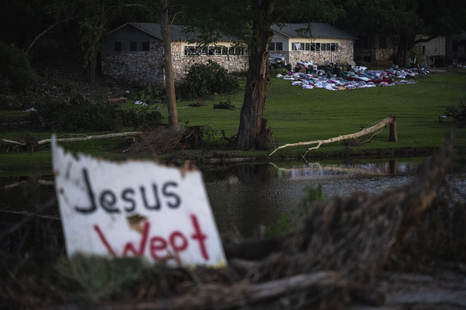 FILE - Camper's belongings sit outside one of Camp Mystic's cabins near the Guadalupe River after a...