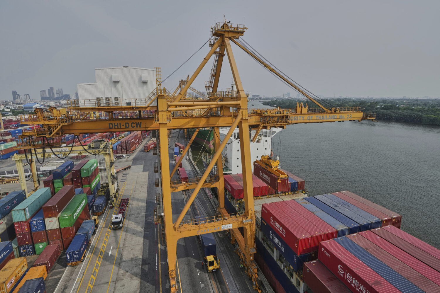 FILE - Cranes work on stacks of containers at the Bangkok Port in Bangkok, Thailand, Thursday, Apri...