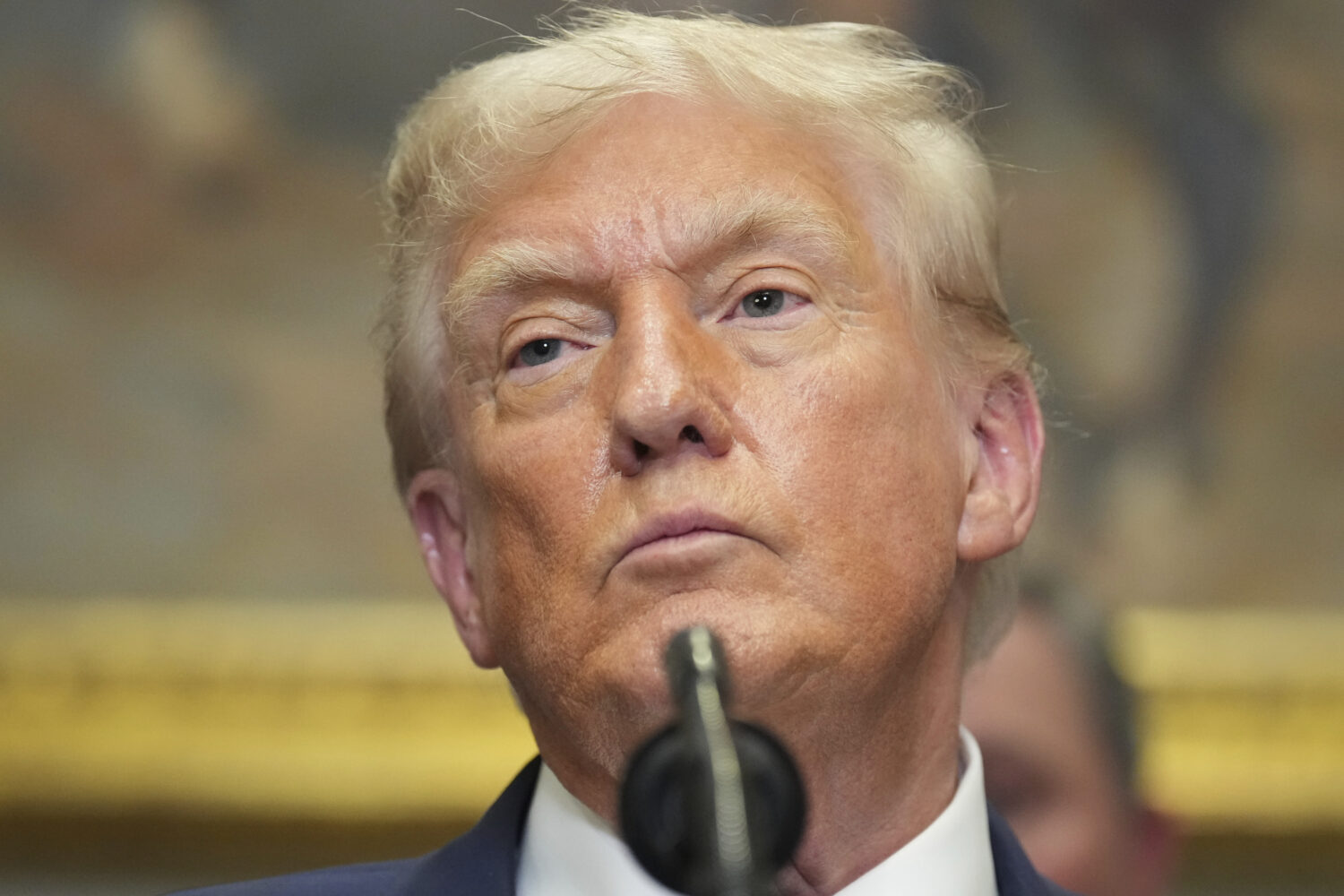 President Donald Trump listens during an event to sign an executive order restarting the Presidenti...
