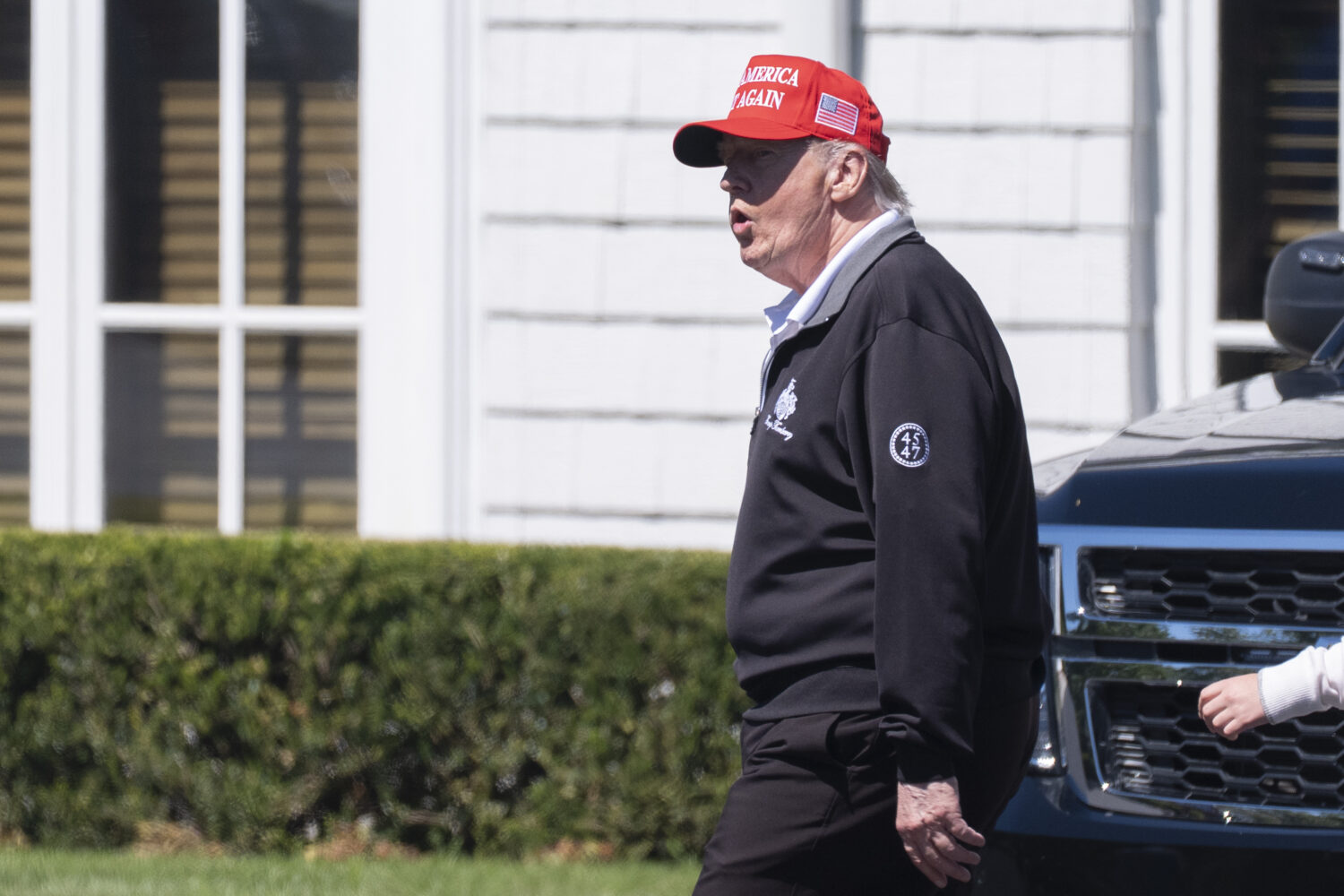 President Donald Trump walks at the Trump National Golf Club in Sterling, Va., Saturday, Aug. 30, 2...