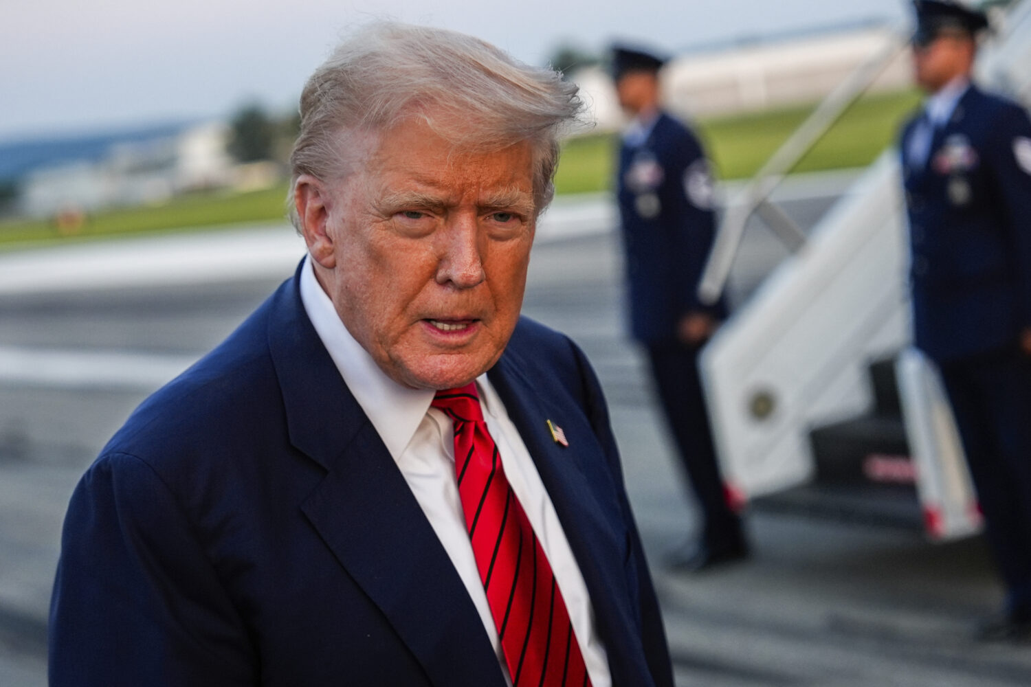 President Donald Trump speaks with reporters before boarding Air Force One at Lehigh Valley Interna...