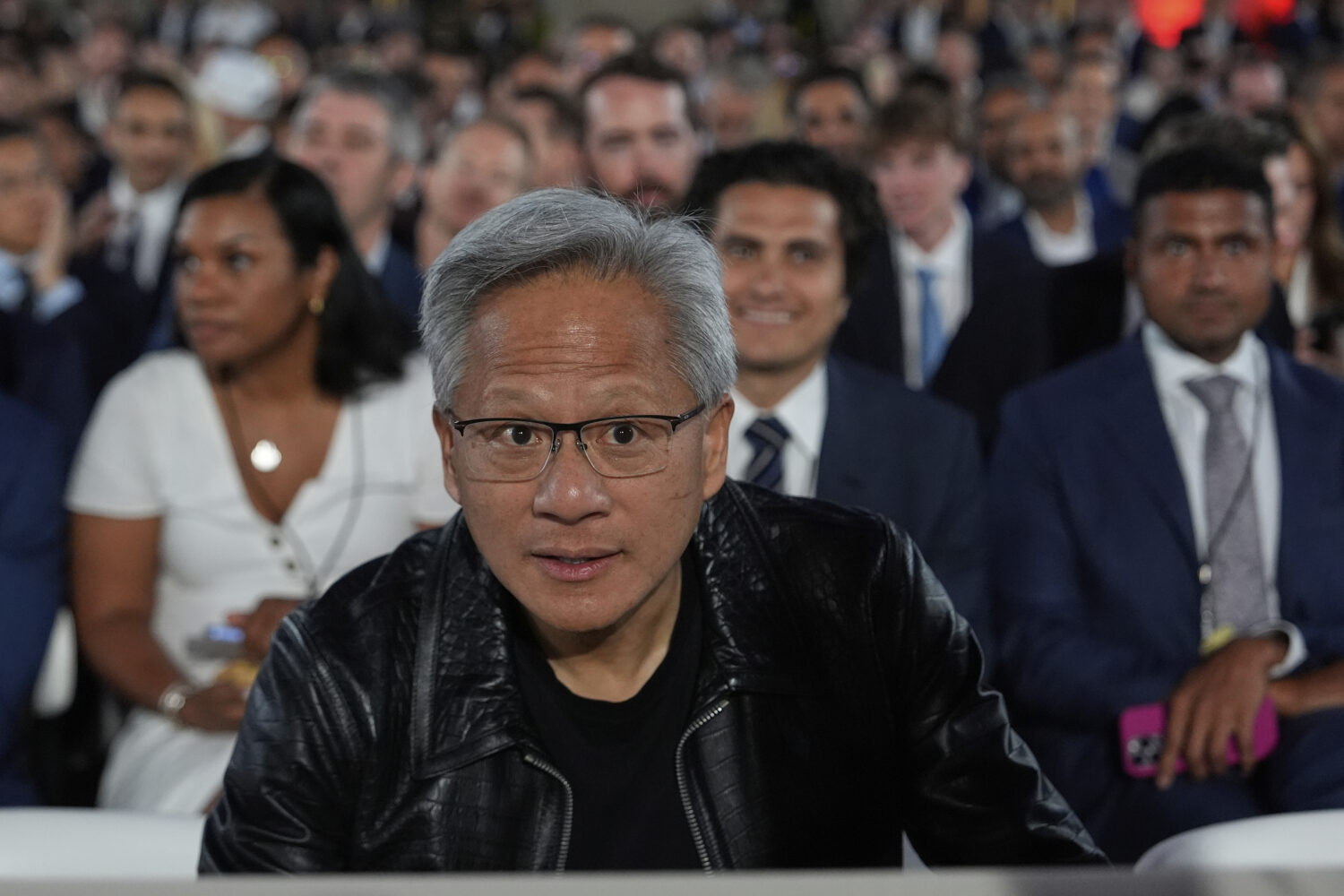 Nvidia CEO Jensen Huang arrives before President Donald Trump speaks during an AI summit at the And...