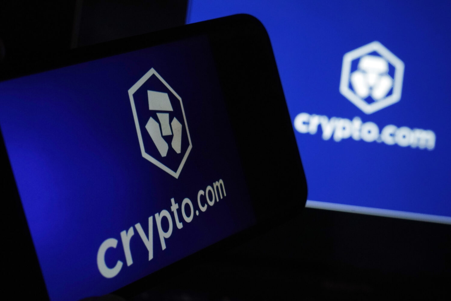 FILE - The logo for crypto.com appears on a mobile phone and computer screen, in New York, Jan. 31,...