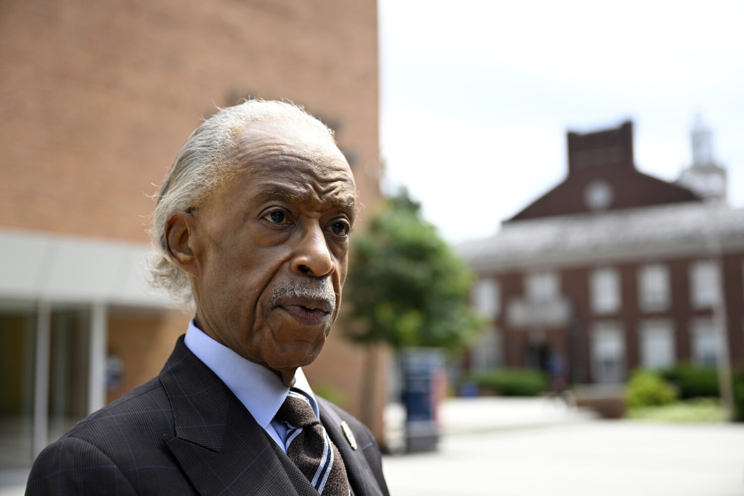 Rev. Al Sharpton speaks with reporters after delivering a sermon at Howard University's Cramton Aud...
