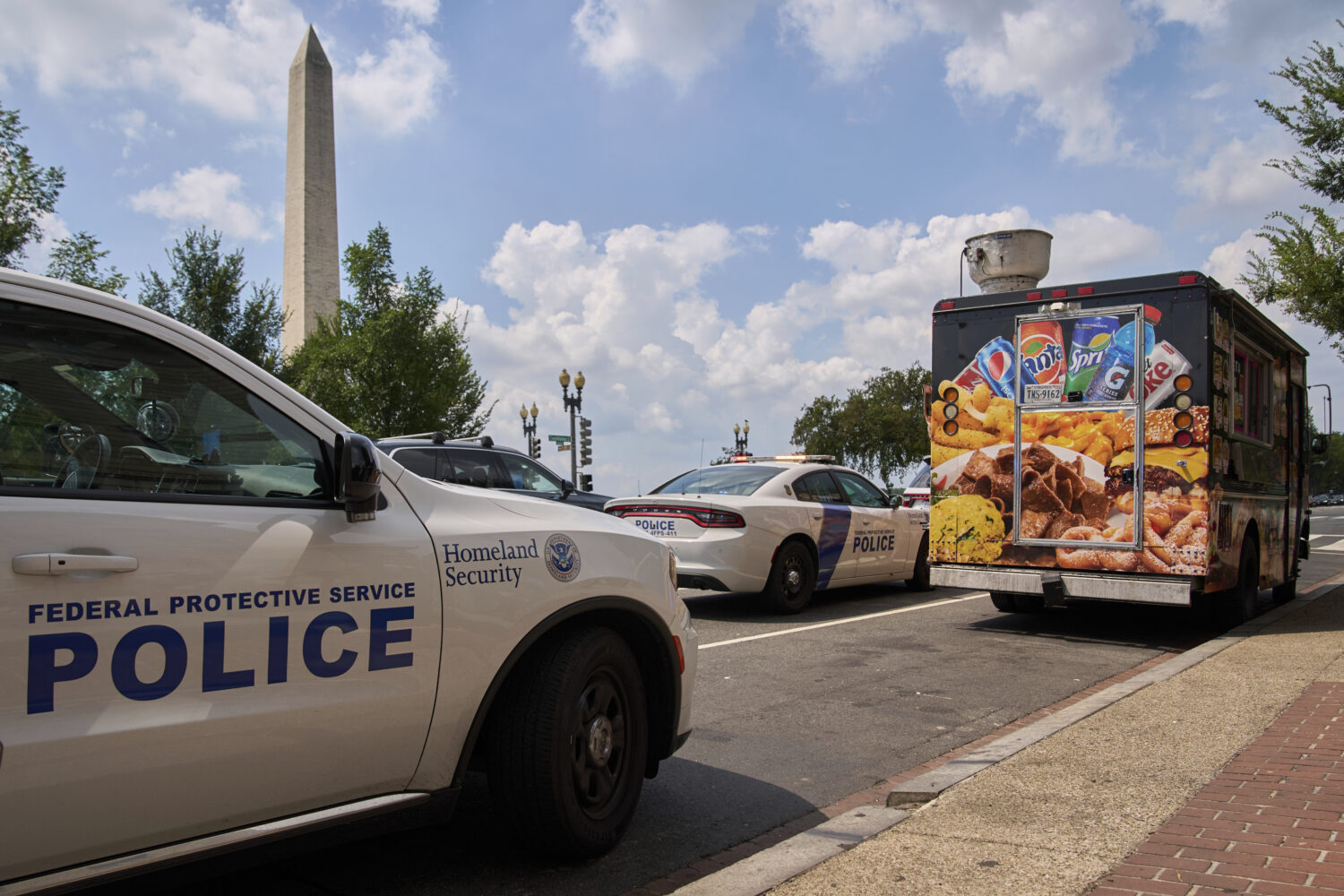 U.S. Department of Homeland Security Federal Protective Services wait on a tow truck to take away a...