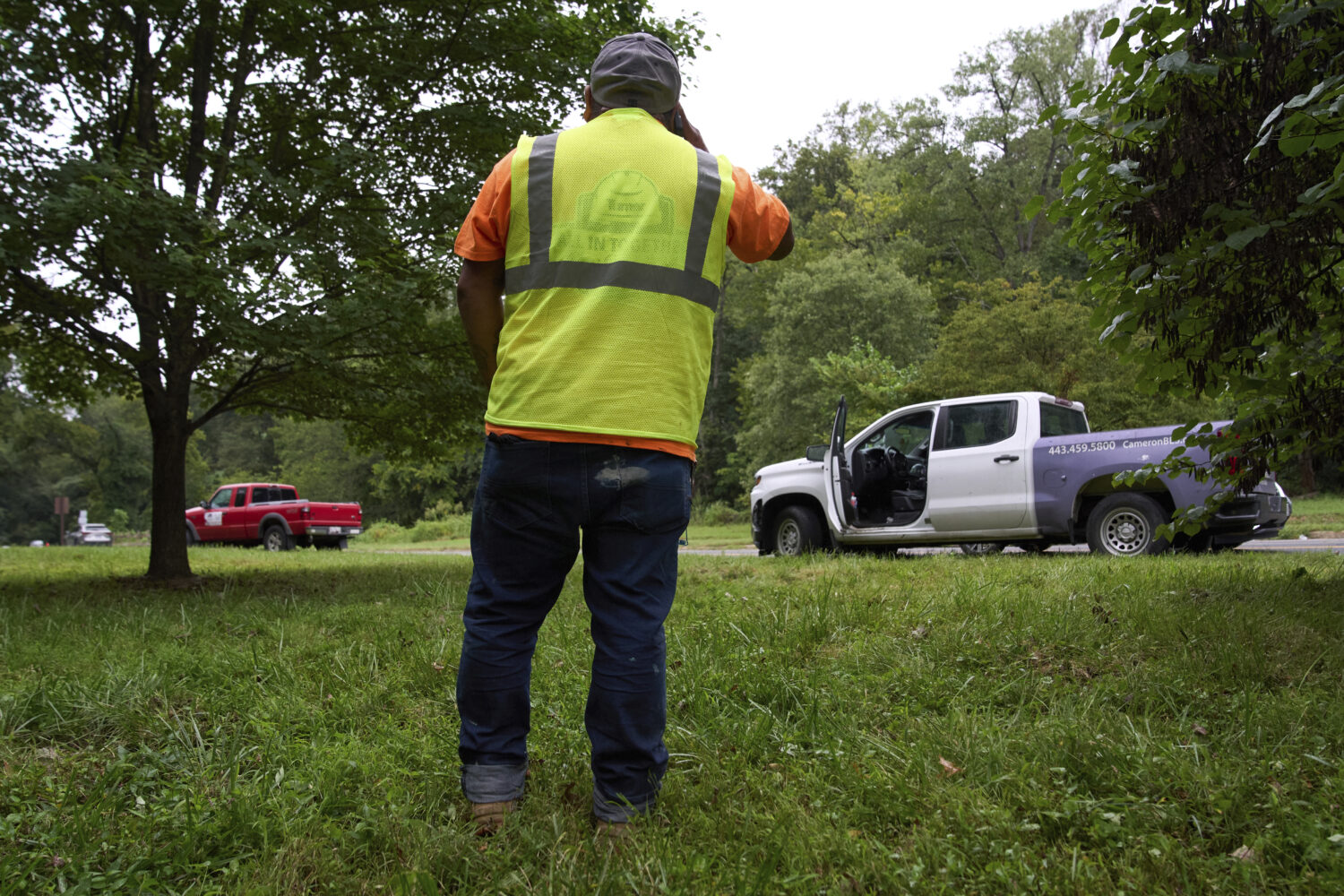 Between a now empty pickup truck and what's left of his work crew at right, Martin Romero, 41, of G...