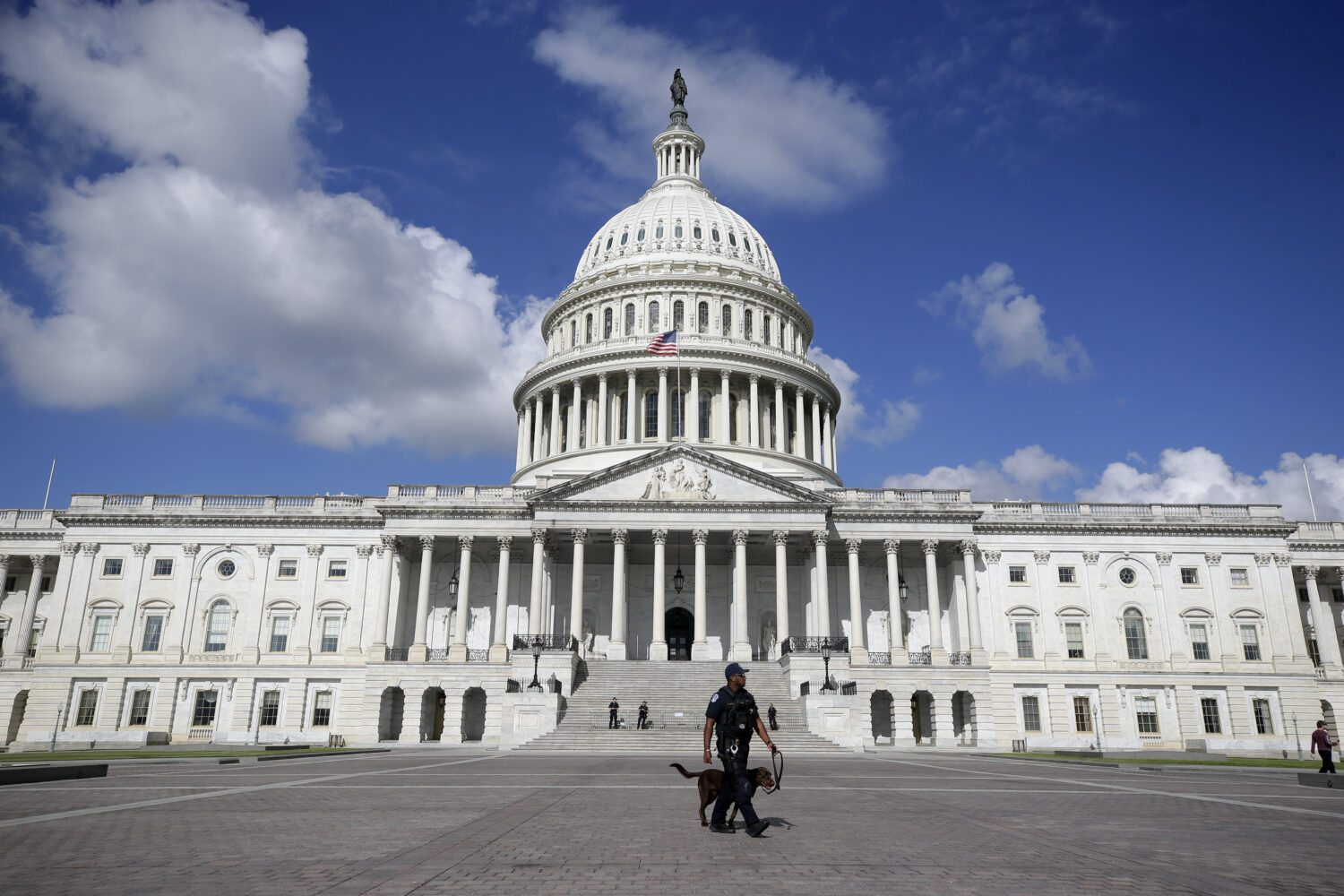A U.S. Capitol Police officer walks in front of the U.S. Capitol, Friday, Aug. 22, 2025, in Washing...