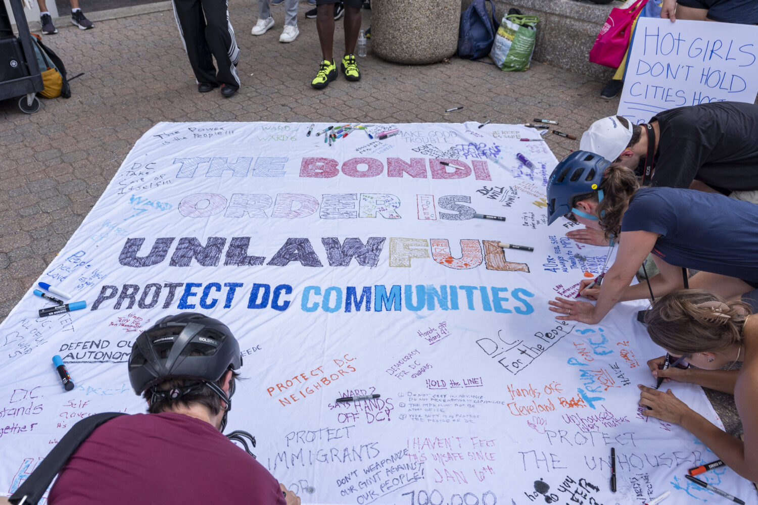 Activists with Free DC work on a banner as they gather outside Washington Metropolitan Police Depar...