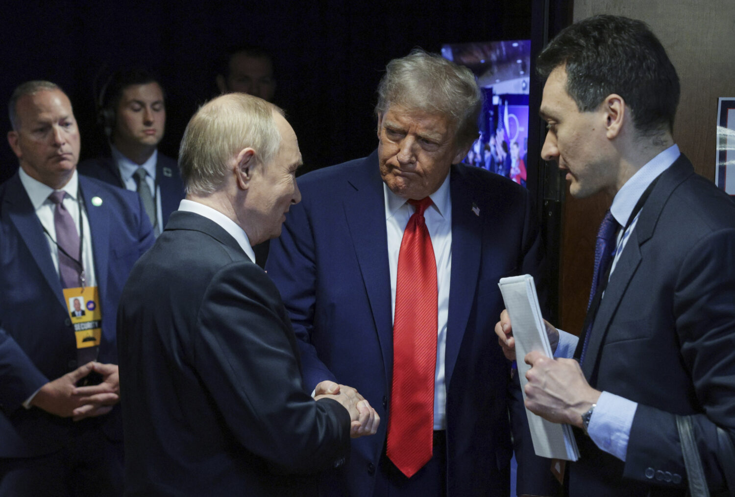 U.S. President Donald Trump, second right, shakes hands with Russian President Vladimir Putin after...