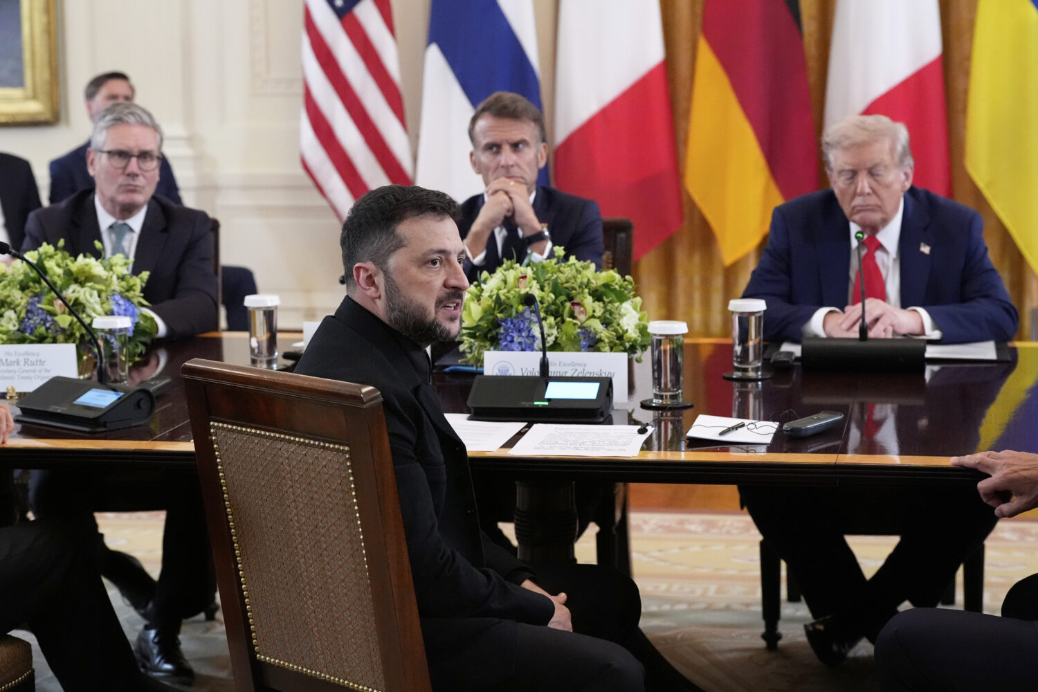 Ukraine's President Volodymyr Zelenskyy speaks as British Prime Minister Keir Starmer, seated from ...