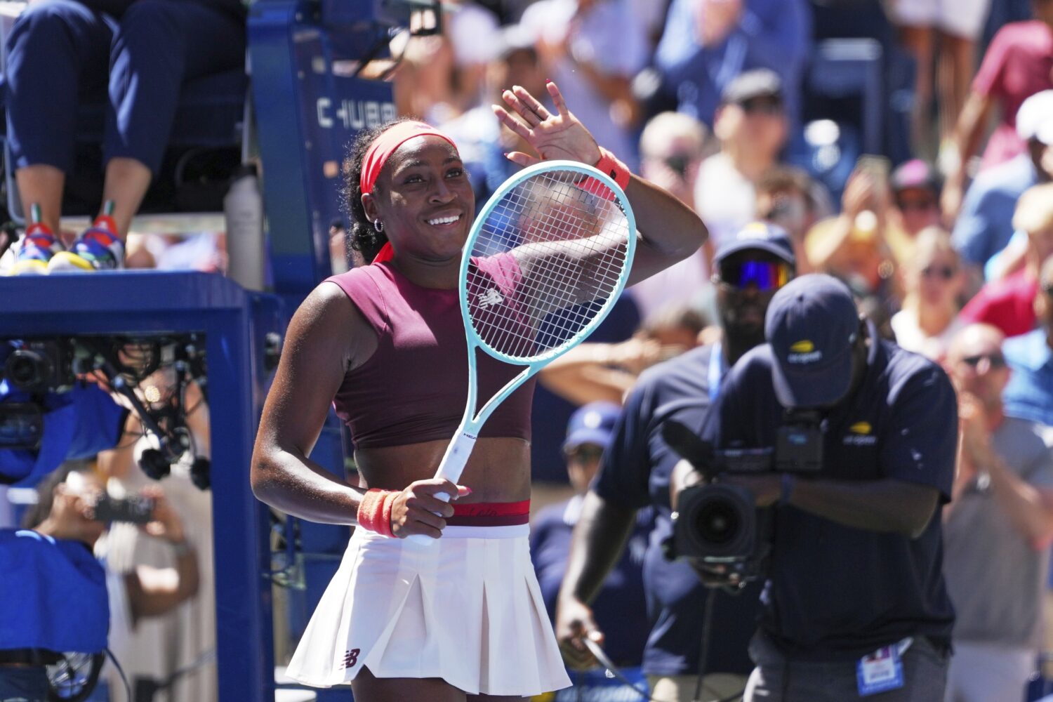 Coco Gauff, of the United States, waves after winning the match point against Magdalena Frech, of P...