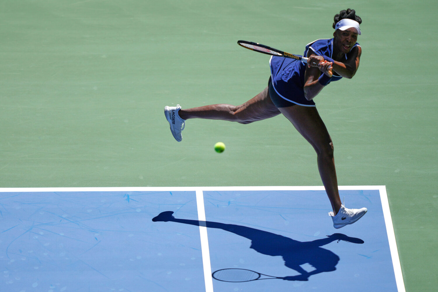 Venus Williams returns a shot during the mixed doubles competition of the U.S. Open tennis tourname...