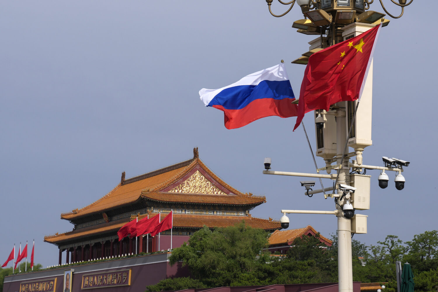 FILE - A Russian and Chinese national flag flutter near Tiananmen Gate for the visiting Russia's Pr...