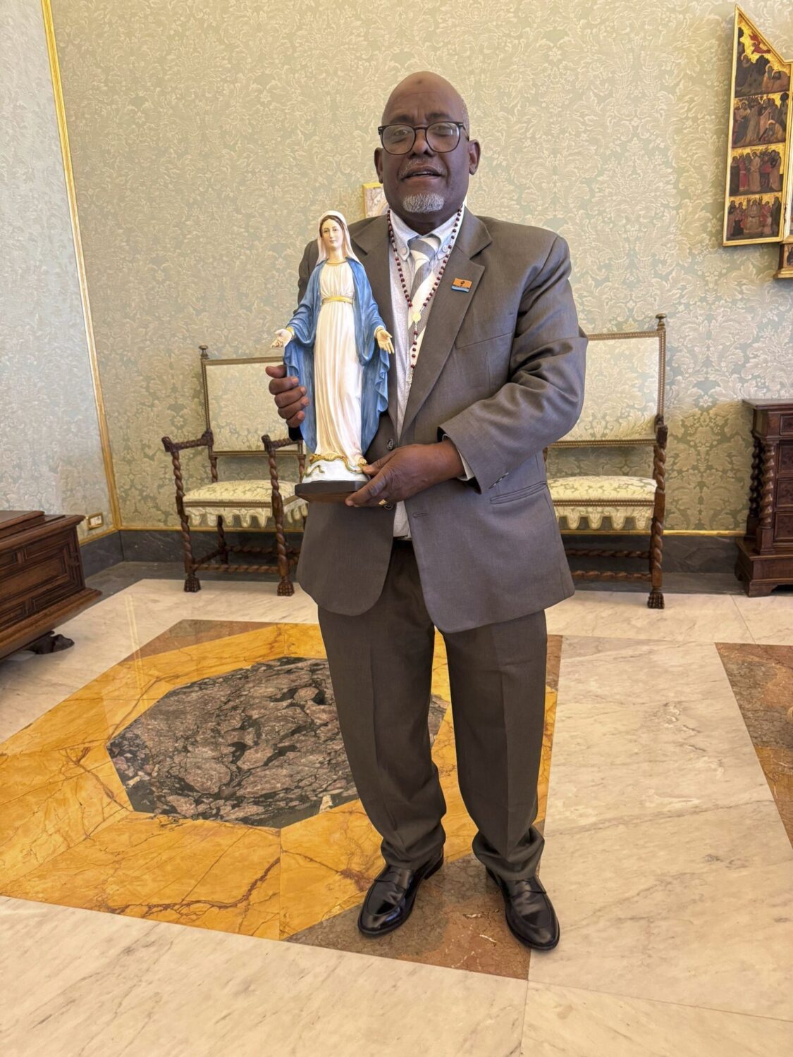 President of Chagos Refugees Group Louis Olivier Bancoult holds a statue of the Virgin at the Vatic...