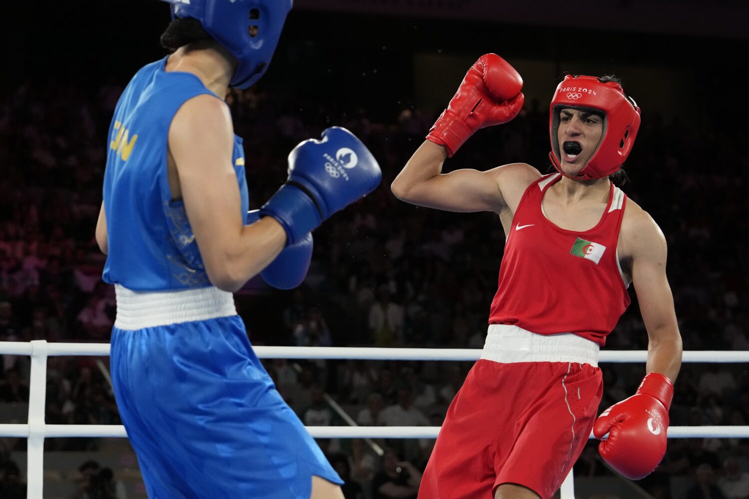 FILE - Algeria's Imane Khelif, right, fights China's Yang Liu in their women's 66 kg final boxing m...