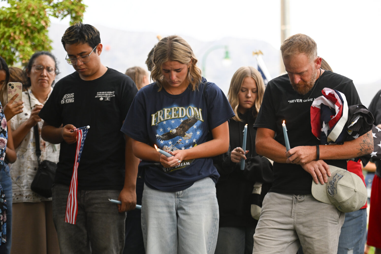 People attend a vigil at Timpanogos Regional Hospital for Charlie Kirk, the CEO and co-founder of T...