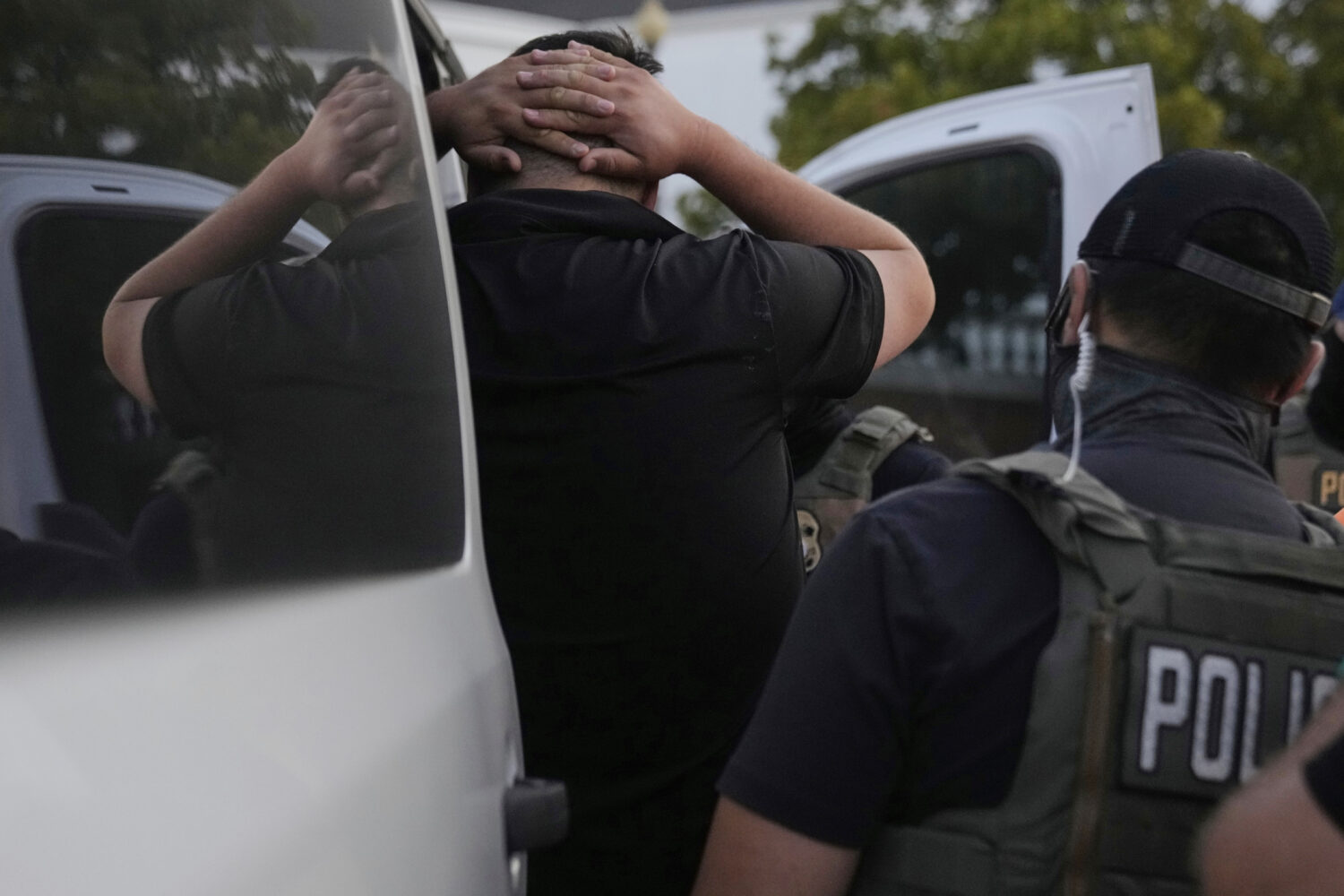 U.S. Immigration and Customs Enforcement agents make an arrest during an early morning operation in...