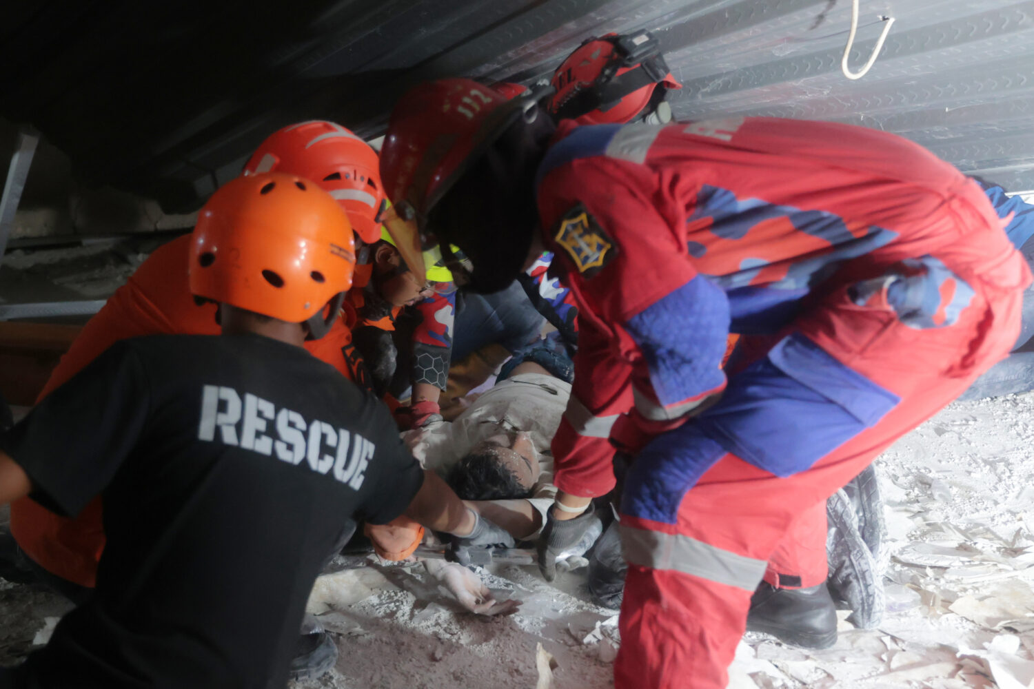 Rescuers pull out a survivor from a collapsed building at an Islamic boarding school in Sidoarjo, E...