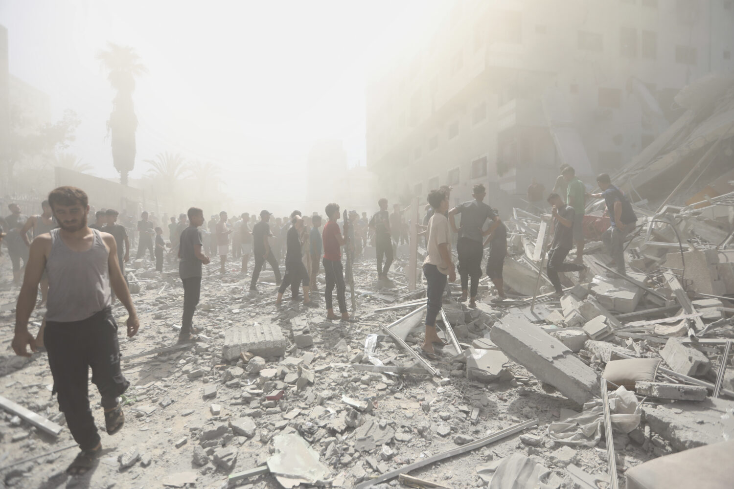 Palestinians inspect the rubble of a building after an Israeli military strike in Gaza City, Sunday...