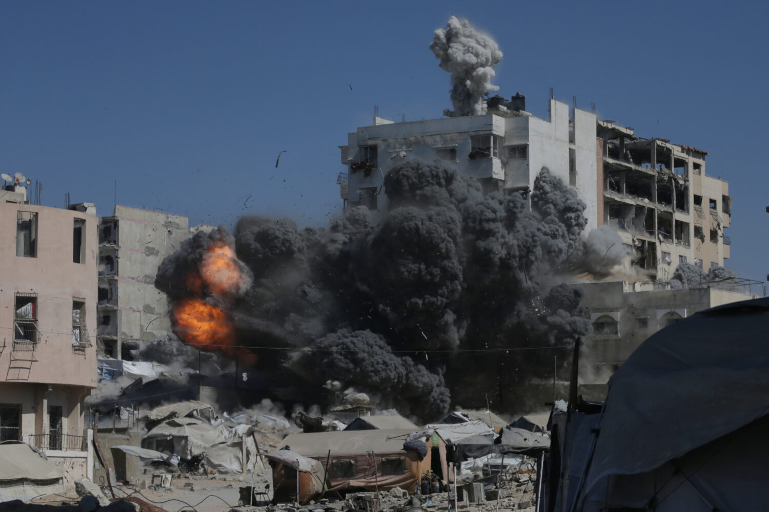 Smoke and flames rise after an Israeli military strike on a building in Gaza City, Friday, Sept. 12...