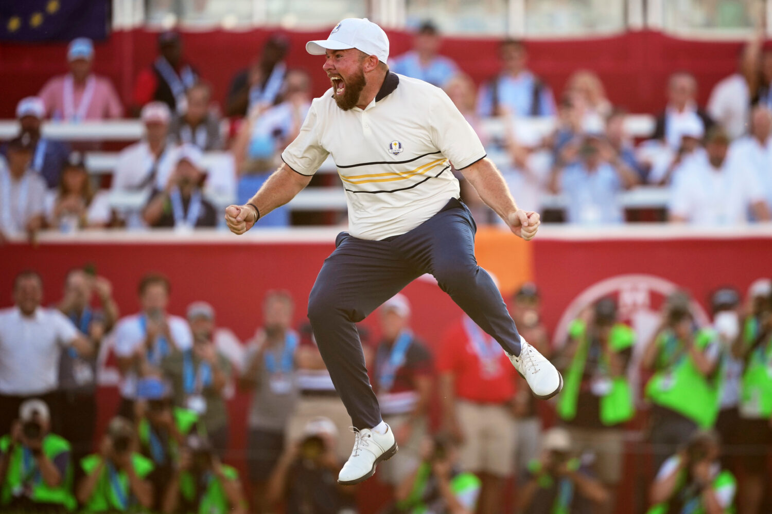 Europe's Shane Lowry celebrates after making the winning putt putt on the 18th hole during their si...