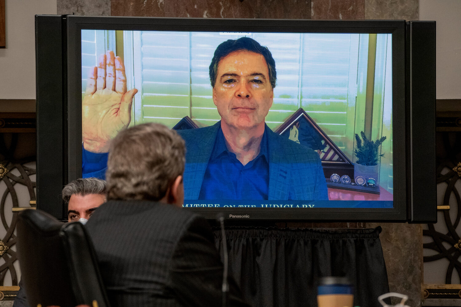 FILE - Former FBI director James Comey is sworn via videoconference before testifying during a Sena...