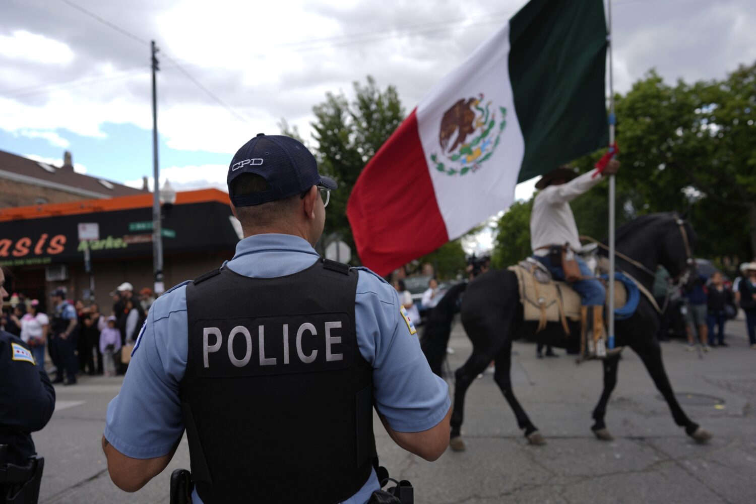 Police watch during the 2025 Pilsen Mexican Independence Day parade Saturday, Sept. 6, 2025, in Chi...