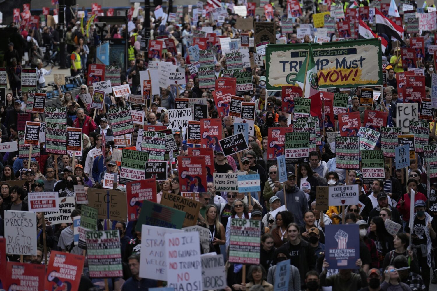 People march during Illinois Coalition for Immigrant & Refugee Rights' "Chicago Says No Trump No Tr...