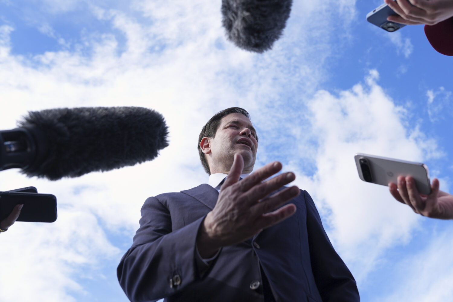 Secretary of State Marco Rubio speaks to reporters before boarding his plane at Homestead Air Reser...
