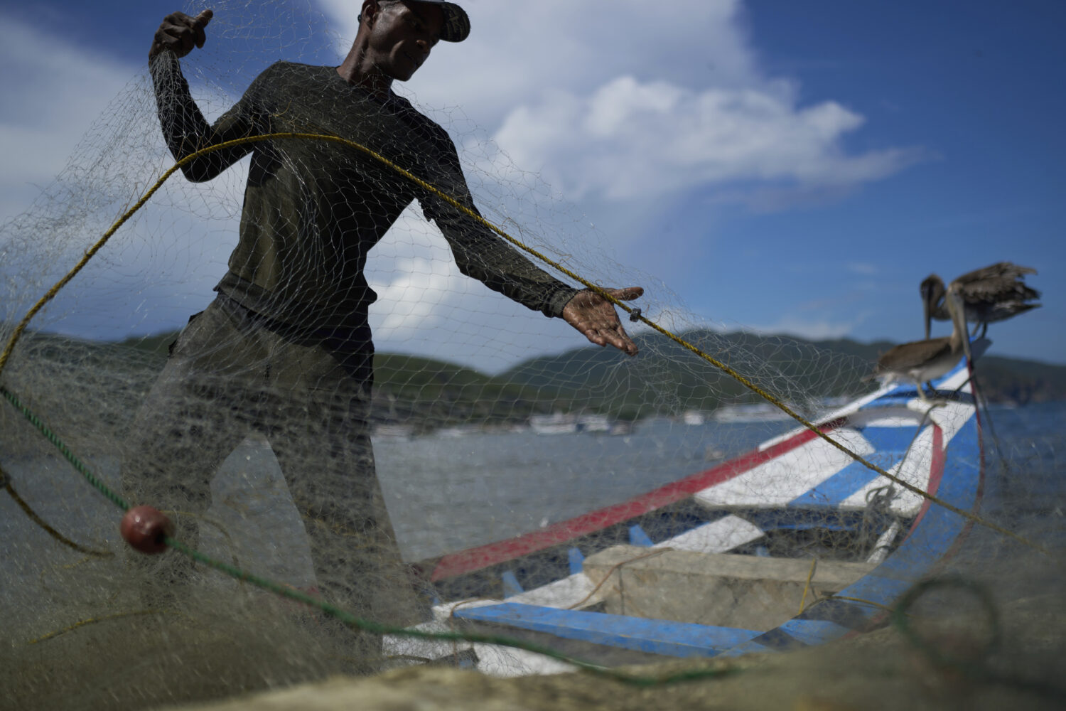 A fisherman prepares his net in the fishing community of El Morro de Puerto Santo, on Venezuela's P...