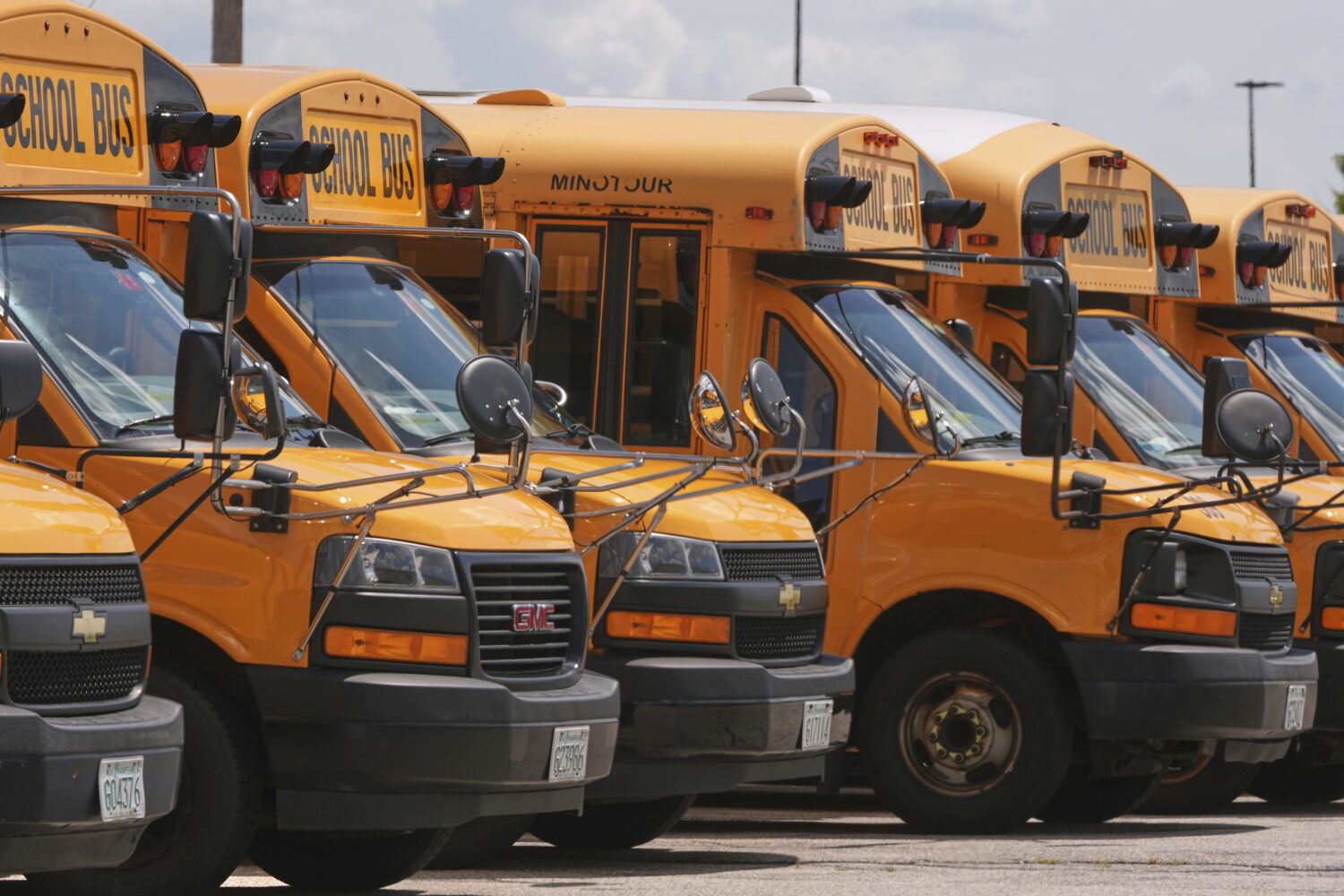 FILE - School buses are lined up in a storage lot, Aug. 14, 2025, in Manchester, N.H. (AP Photo/Cha...