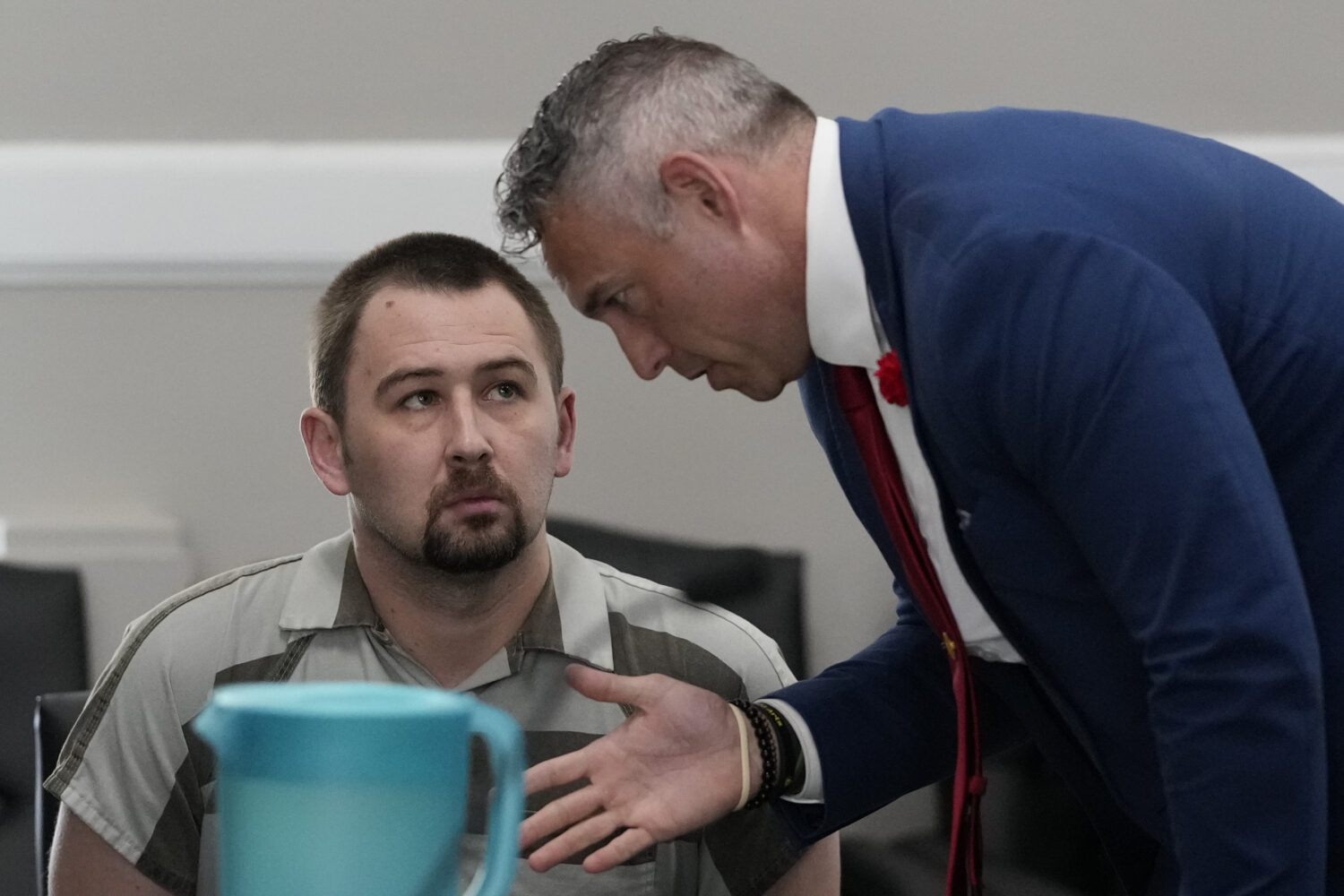 Defendant Austin Drummond, left, accused of quadruple murder, speaks to his attorney Jere Mason, ri...