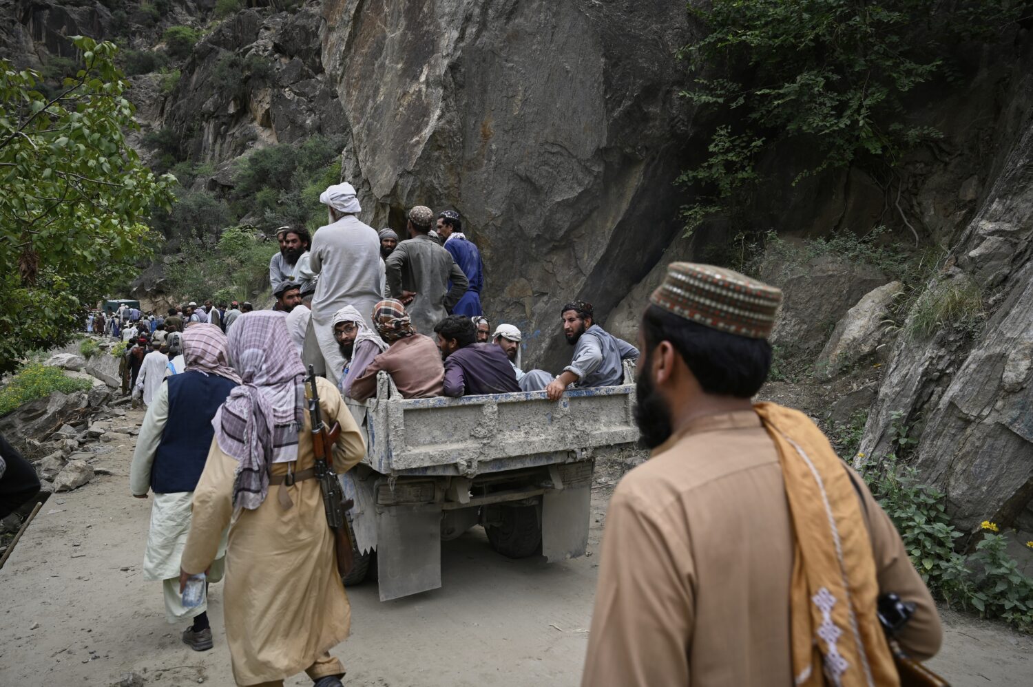 Residents from surrounding towns and villages try to reach the quake-hit region to assist survivors...