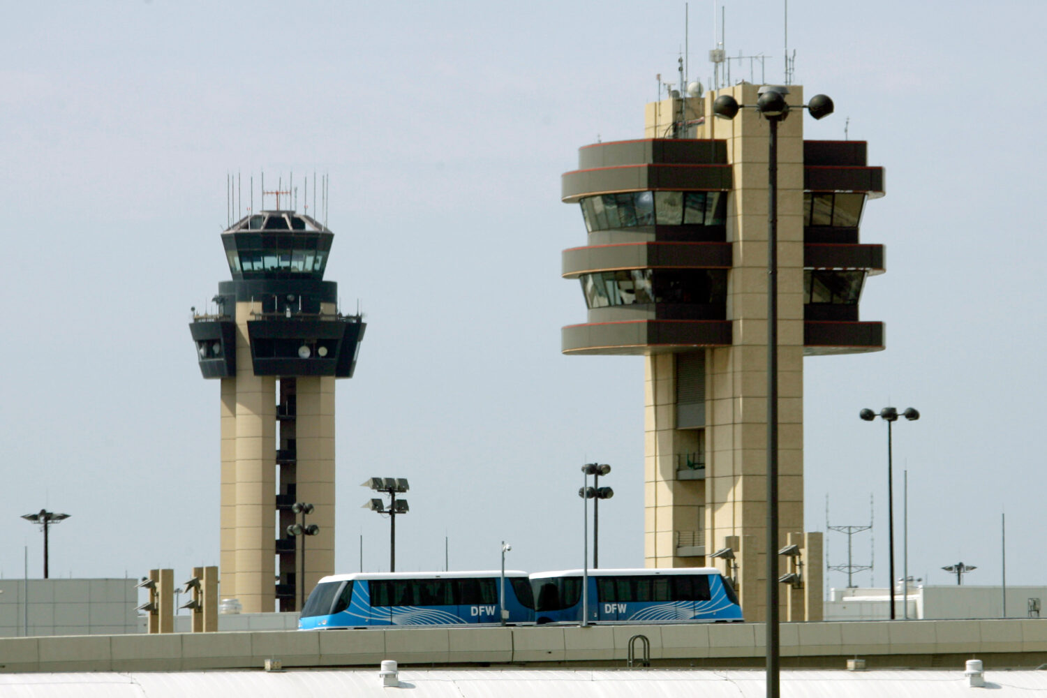 FILE - A Skylink tram passes in front of control towers at the Dallas-Fort Worth International Airp...