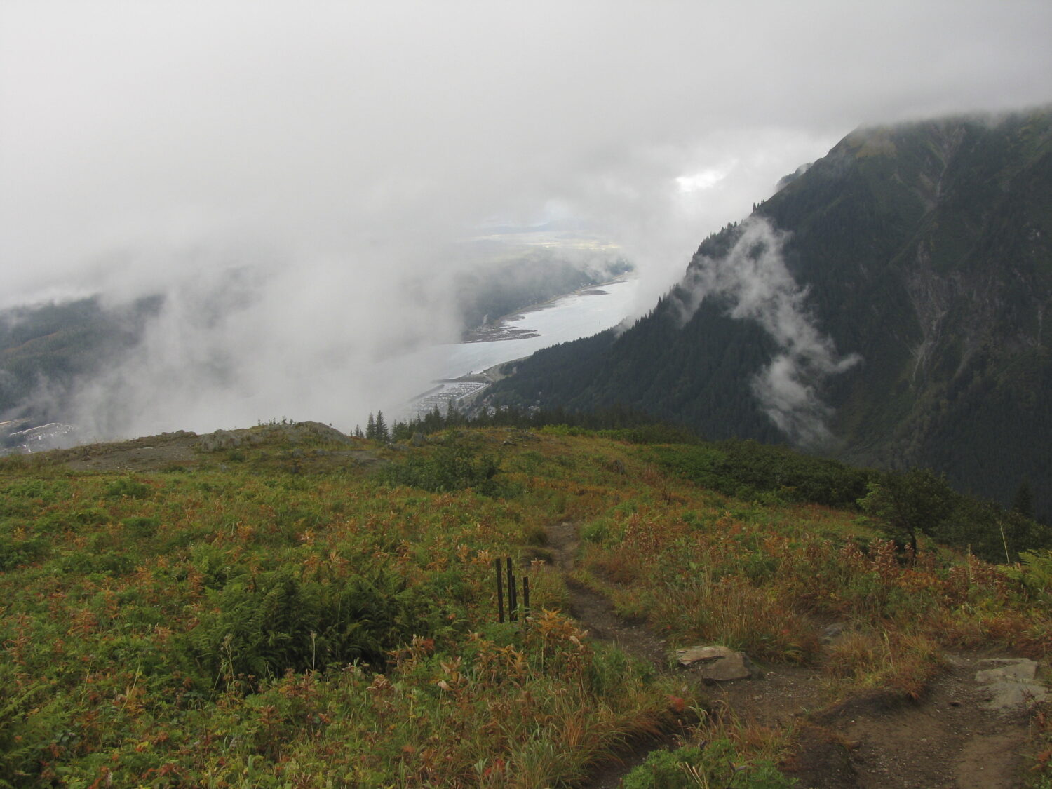 FILE - Clouds and fog hang in the area near and along Mount Roberts trail on Sept. 22, 2012, in Jun...