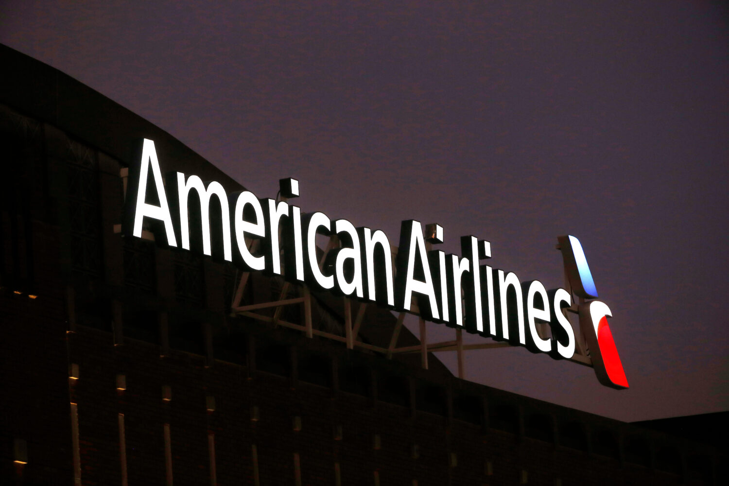 FILE - The American Airlines logo is seen atop the American Airlines Center in Dallas, Dec. 19, 201...