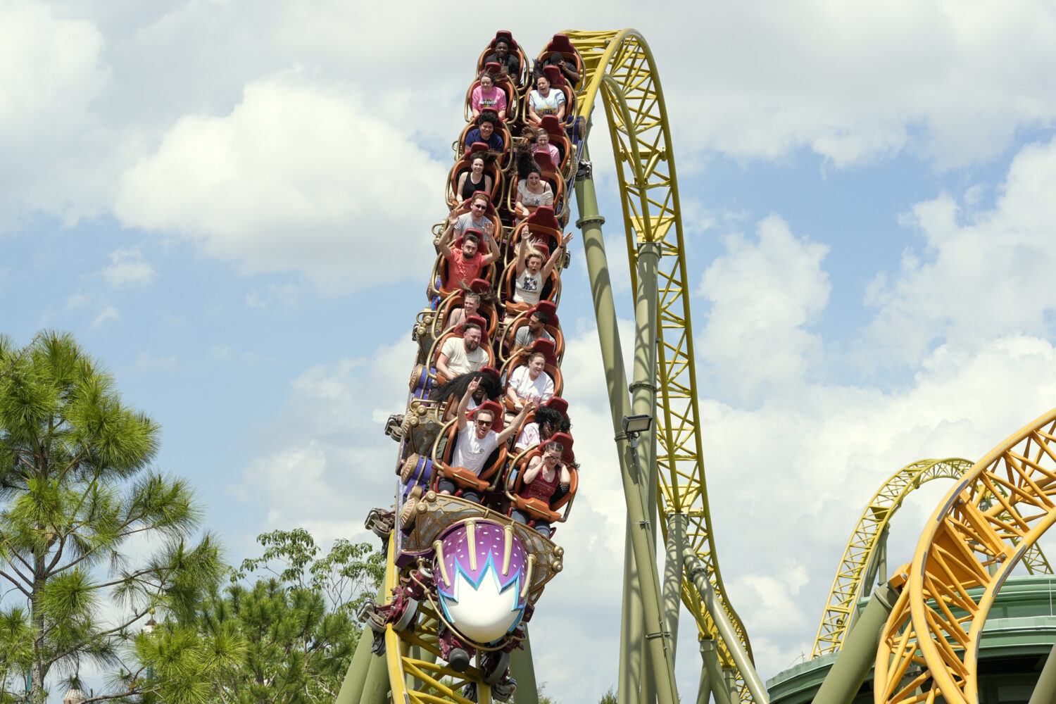 FILE - Guests ride on the Stardust Racers roller coaster at Epic Universe Theme Park at Universal R...
