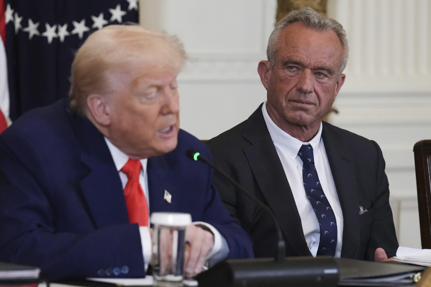 FILE - President Donald Trump, left, speaks as Health and Human Services Secretary Robert F. Kenned...