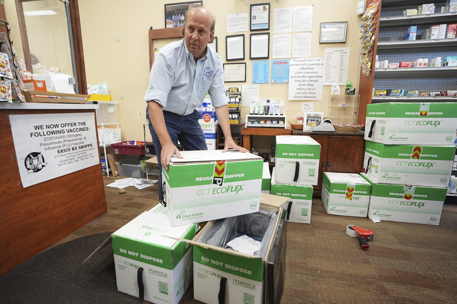Co-owner Eric Abramowitz at Eric's Rx Shoppe unpacks a shipment of COVID-19 vaccines at the store i...