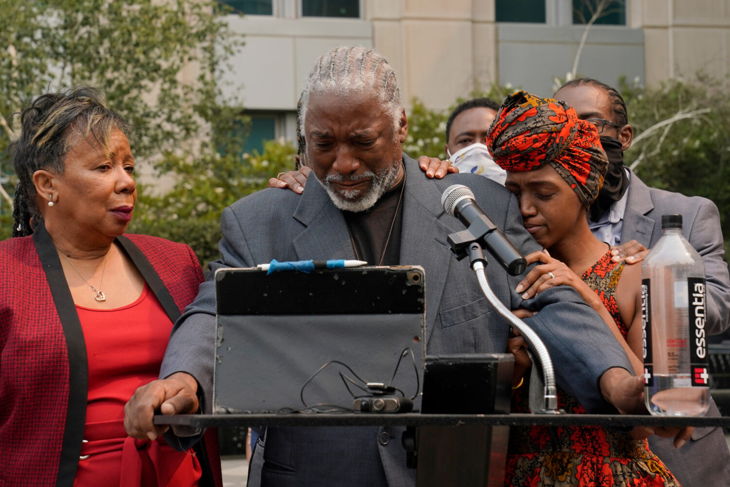 FILE - Joe Powell is comforted by his daughter, Nakia Porter, right, during a news conference to an...