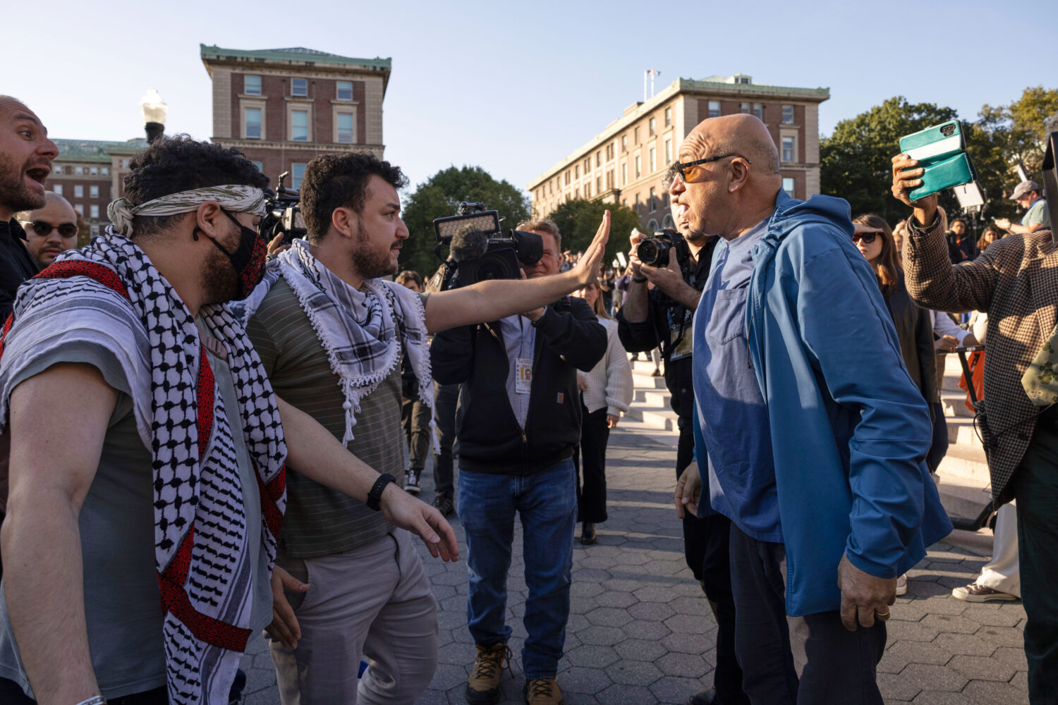 FILE - Pro-Palestinian demonstrator Mahmoud Khalil, second from left, debates with a pro-Israel dem...