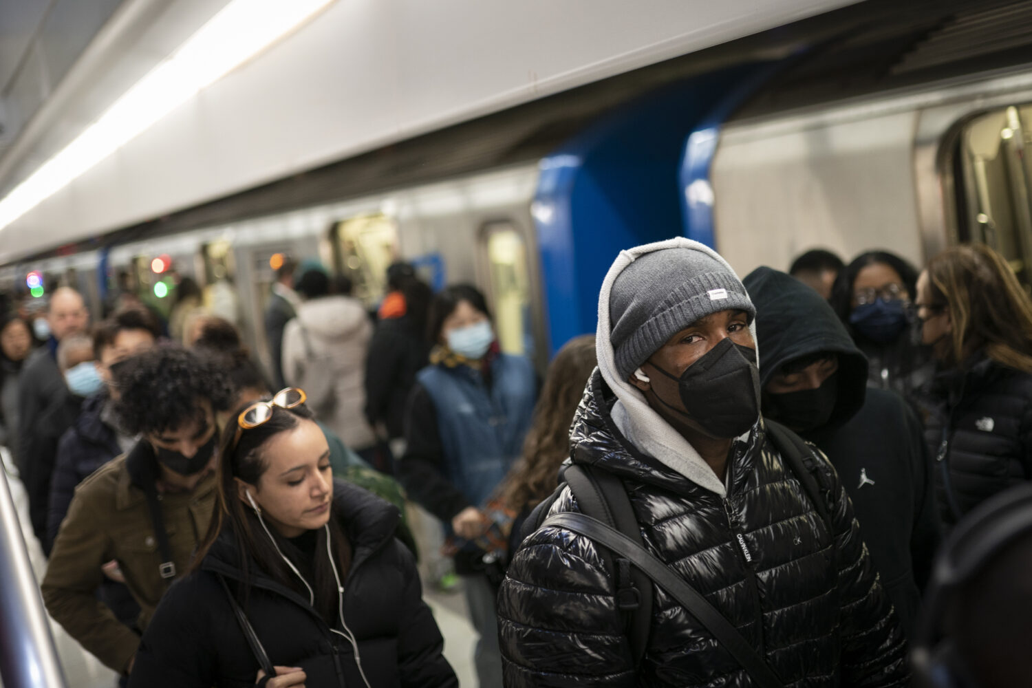 FILE - Mass transit riders commute in the financial district of lower Manhattan, Tuesday, April 19,...