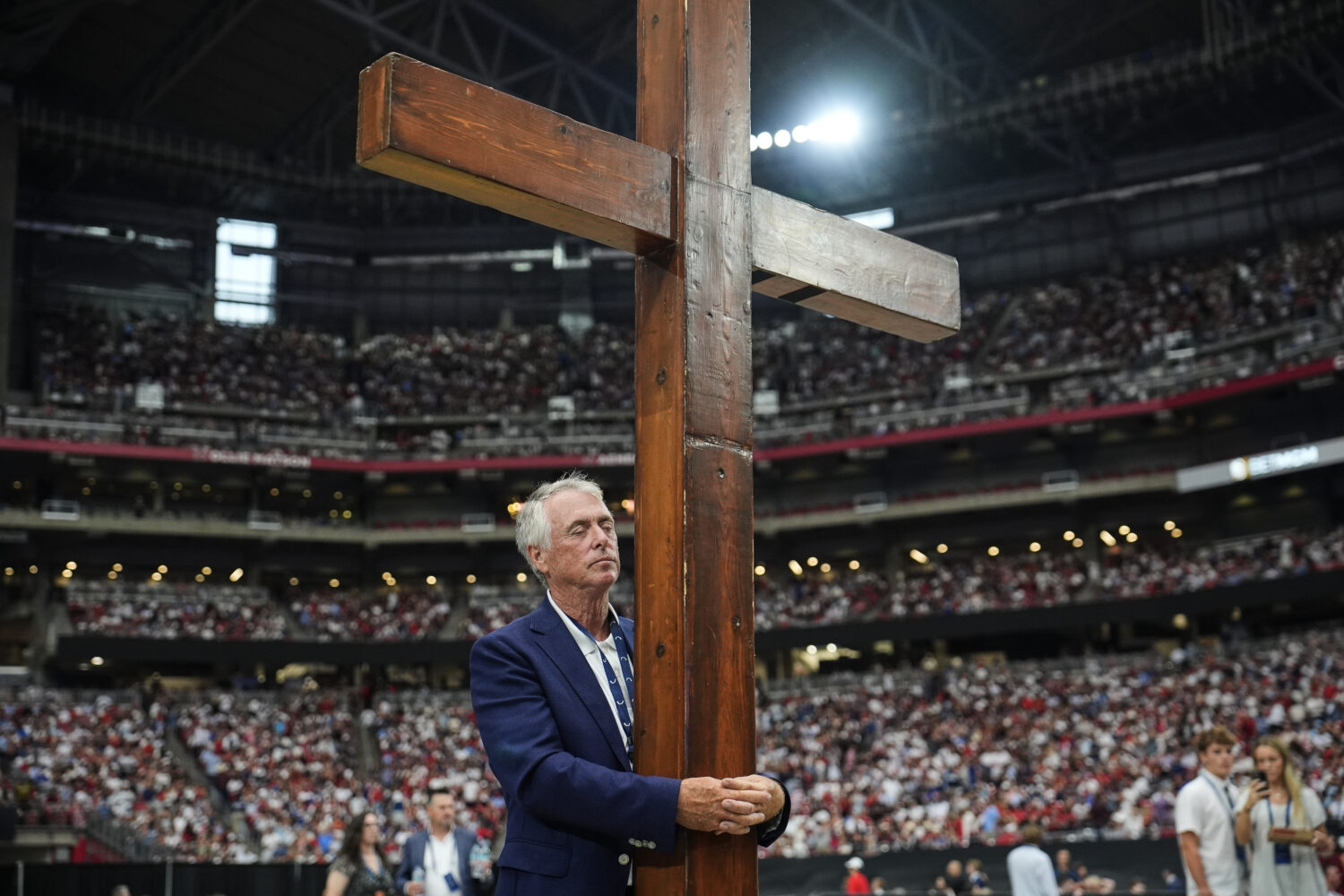 Dan Beazley stands with a cross at a memorial for conservative activist Charlie Kirk, Sunday, Sept....