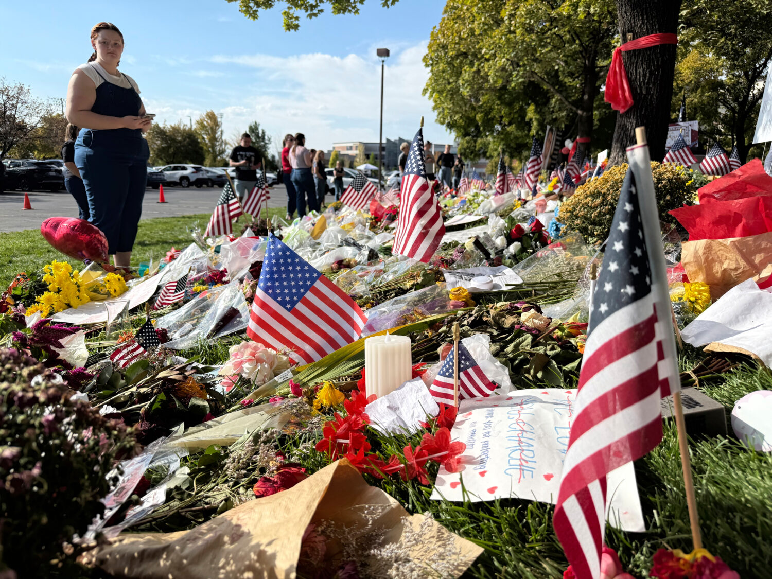 American flags and flowers are displayed at a memorial for Charlie Kirk at Utah Valley University, ...