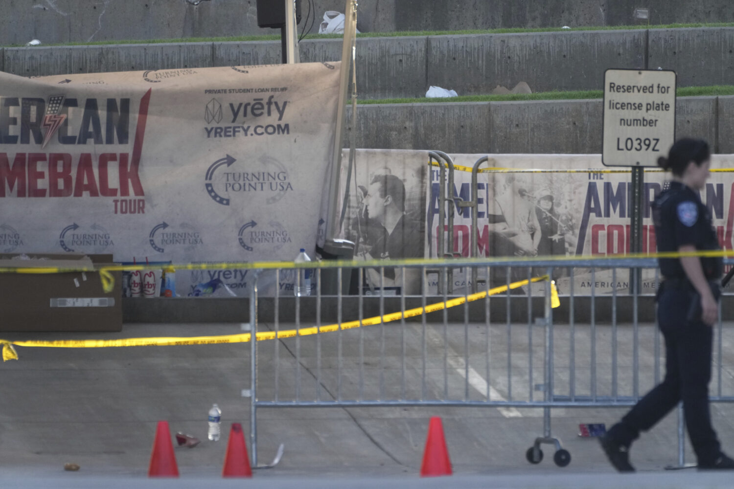 A police officer walks near the scene of the shooting of Charlie Kirk at Utah Valley University in ...