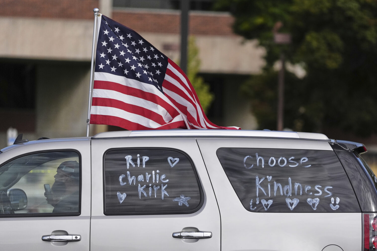 A vehicle marked with messages written on its windows in tribute to Turning Point USA CEO and co-fo...